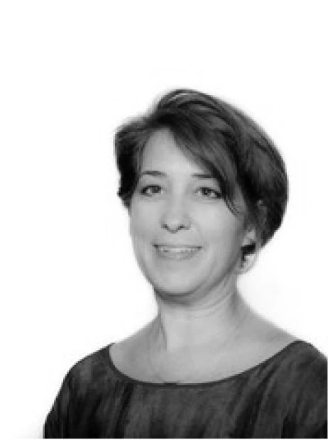Barb, team member at Bidbuddy, in a black and white headshot with short hair and a soft smile.