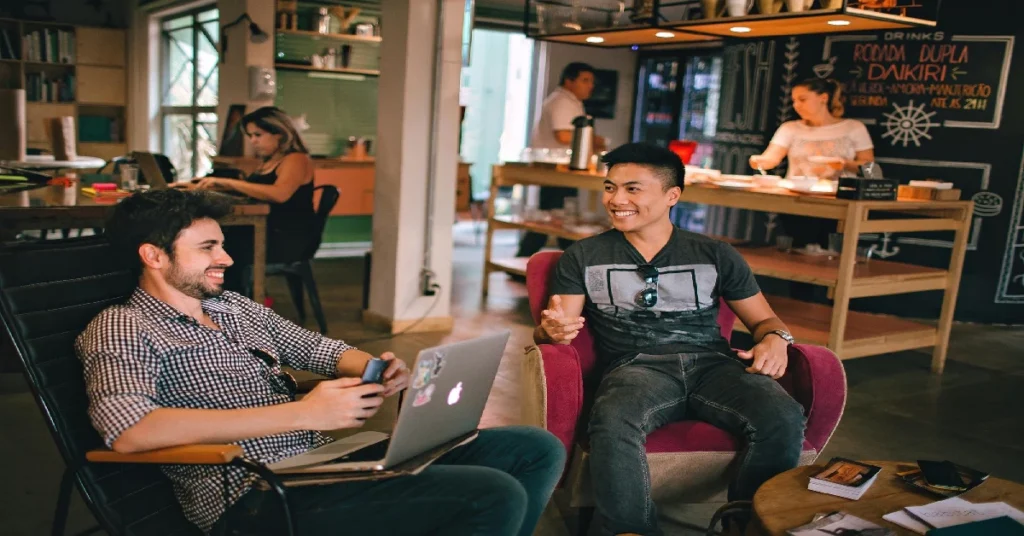 Friends enjoying coffee at a trendy cafe lounge.