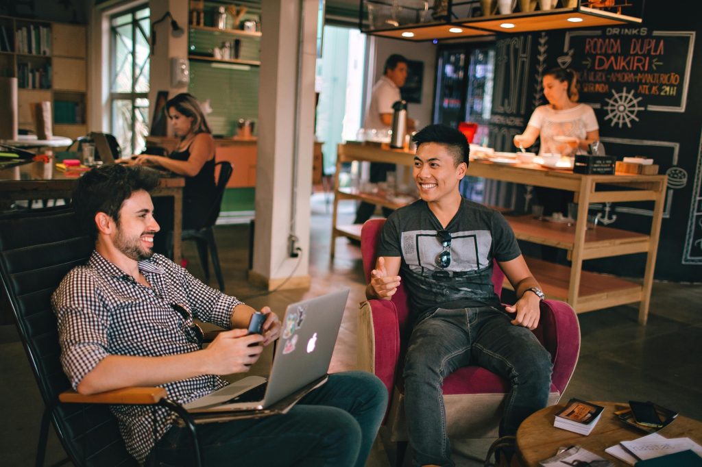 Two professionals discussing at a café table — featured image for article on the role of a tender consultant in simplifying the bidding process.