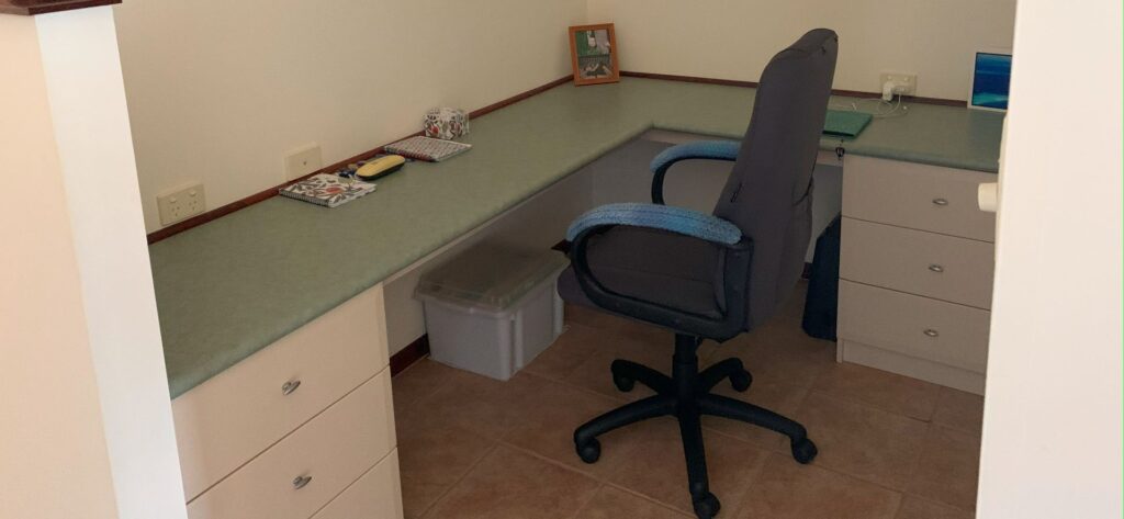 Home office corner with desk and chair setup.
