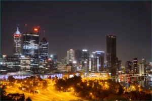 Perth city skyline at night, bright lights shining.